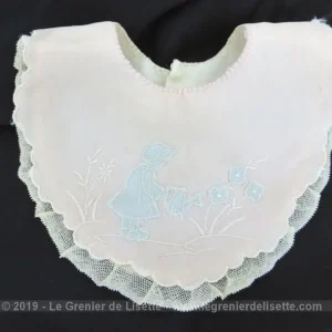 Ancien petit bavoir rose décor incrustations bleues